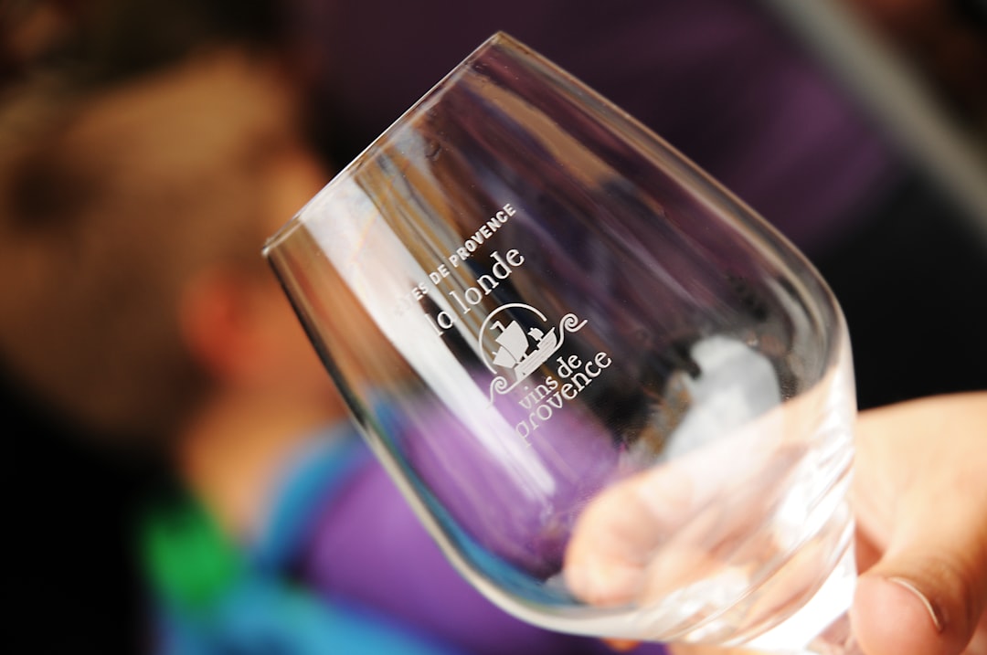 person holding clear drinking glass