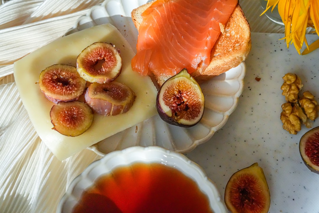 Smoked salmon, figs, cheese, and walnuts on a table.